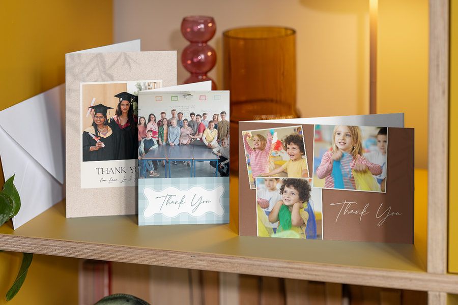 Une sélection de cartes merci prof personnalisées Photobox est présentée côte à côte sur une étagère, pour inspirer un message de remerciement pour prof simple, sincère et de fin d’année.